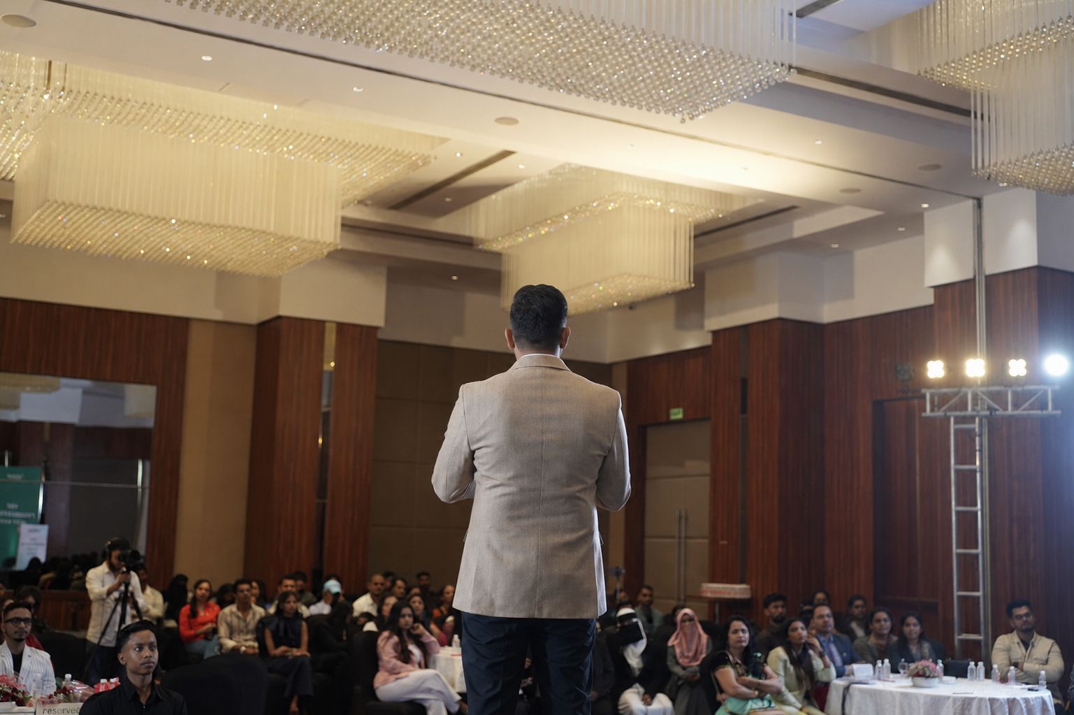 Speaker on stage at an ixiiy event